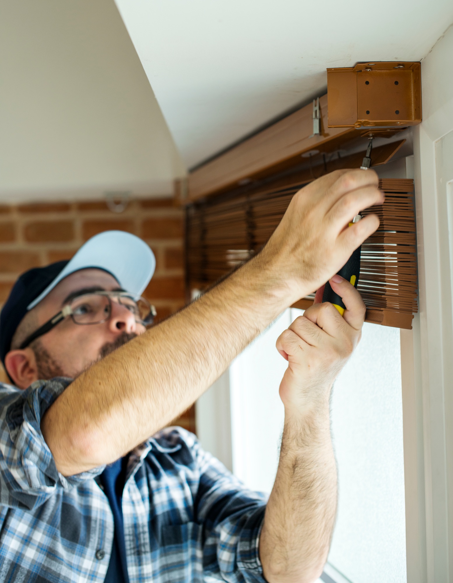 People installing window curtain